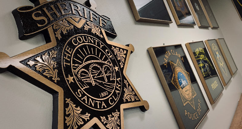 Sheriff logos in frames on a wall